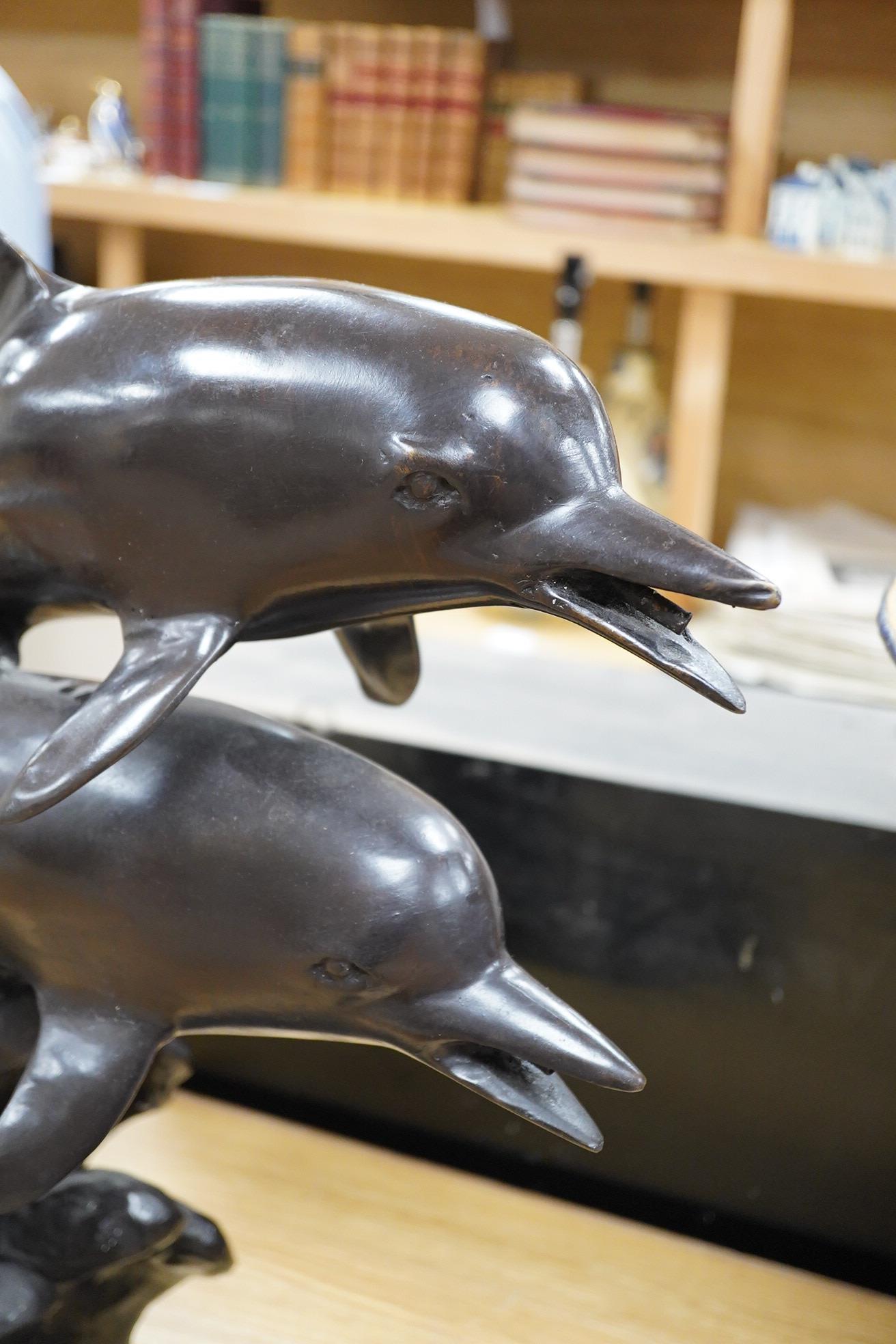A large contemporary bronze dolphin fountain water feature, 61cm high